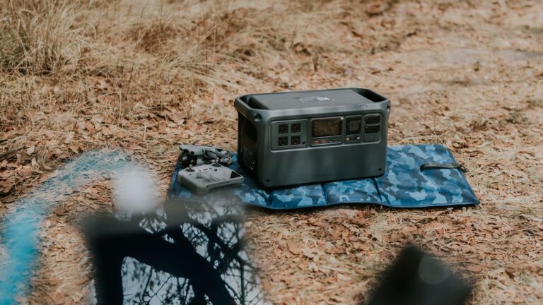 Portable power station on a camping blanket outdoors